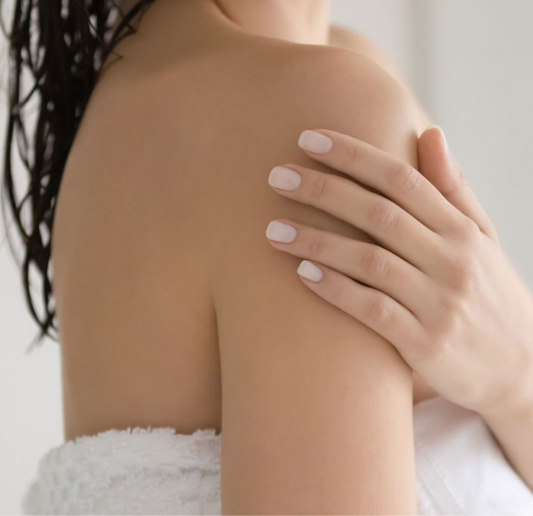 woman feeling her smooth skin