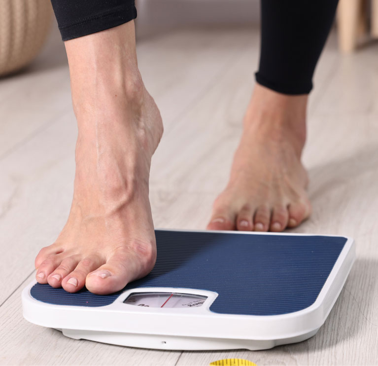 woman stepping on the scale woman stepping on the scale