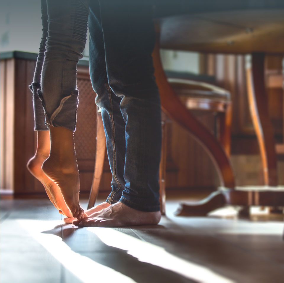 mishawaka woman on tip toes in front of man
