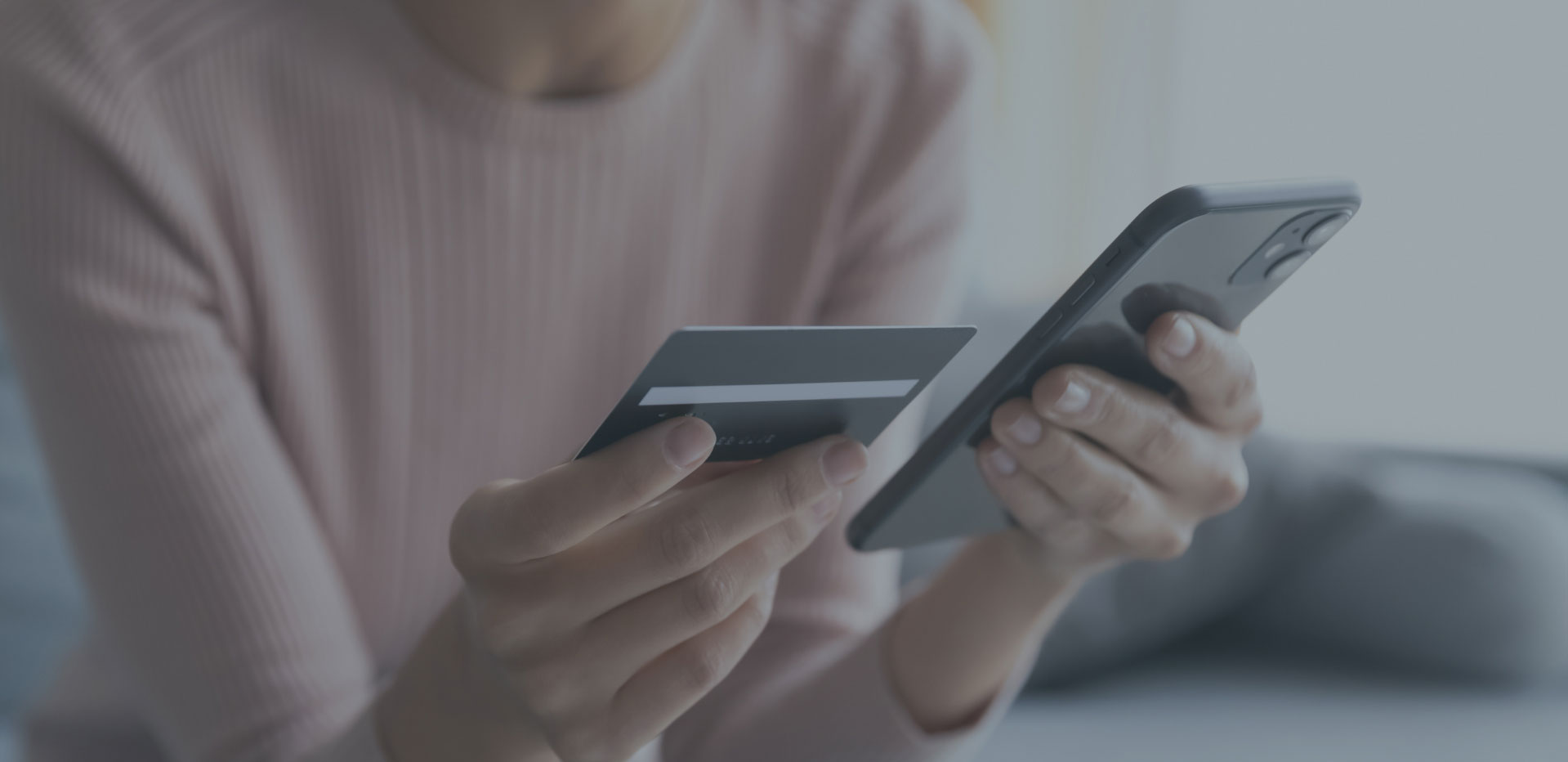 woman entering credit card info into phone